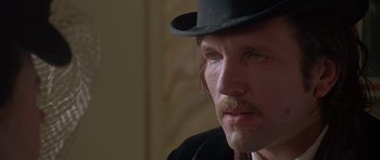 Movie still from “The Portrait of a Lady” (1996), directed by Jane Campion – A person wearing a top hat; Close Up shot, Low angle