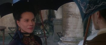 Movie still from “The Portrait of a Lady” (1996), directed by Jane Campion – A woman holding an open umbrella in the rain; Close Up shot, Over the shoulder angle