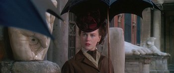 Movie still from “The Portrait of a Lady” (1996), directed by Jane Campion – A woman in a brown coat holding an umbrella; Close Up shot, Over the shoulder angle
