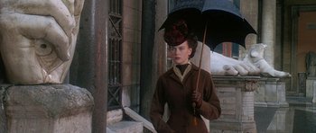 Movie still from “The Portrait of a Lady” (1996), directed by Jane Campion – A woman holding an umbrella while standing in the snow; Medium shot, Low angle
