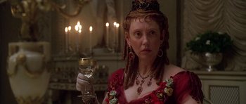 Movie still from “The Portrait of a Lady” (1996), directed by Jane Campion – A woman in a red dress holding a glass of wine; Close Up shot, Over the shoulder angle