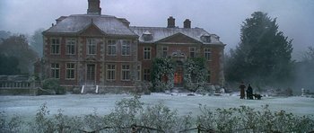 Movie still from “The Portrait of a Lady” (1996), directed by Jane Campion – A large brick building with a large entrance; Extreme Wide shot, Low angle