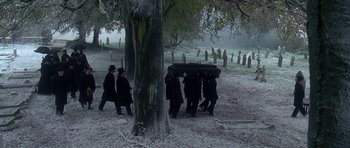 Movie still from “The Portrait of a Lady” (1996), directed by Jane Campion – A group of men carry a casket through a cemetery; Wide shot, High angle