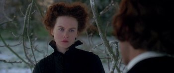 Movie still from “The Portrait of a Lady” (1996), directed by Jane Campion – A woman in a black dress standing next to a tree; Close Up shot, Over the shoulder angle