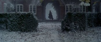 Movie still from “The Portrait of a Lady” (1996), directed by Jane Campion – A woman in a long black dress walking through the snow; Extreme Wide shot, Low angle