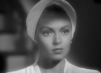 Movie still from “The Postman Always Rings Twice” (1946), directed by Tay Garnett – A black and white photo of a woman with a head scarf; Close Up shot, Low angle