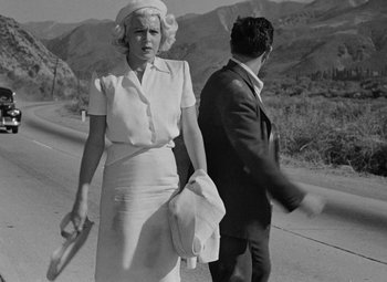 Movie still from “The Postman Always Rings Twice” (1946), directed by Tay Garnett – An old photo of a woman and a man on the side of the road; Medium shot, Low angle