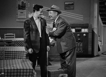 Movie still from “The Postman Always Rings Twice” (1946), directed by Tay Garnett – A man and a man in a suit and tie; Medium shot, Over the shoulder angle