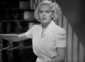 Movie still from “The Postman Always Rings Twice” (1946), directed by Tay Garnett – A black - and - white photo of a woman with blonde ringlets; Close Up shot, Over the shoulder angle