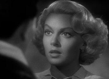 Movie still from “The Postman Always Rings Twice” (1946), directed by Tay Garnett – A black - and - white photo of a woman in a dress; Close Up shot, Over the shoulder angle