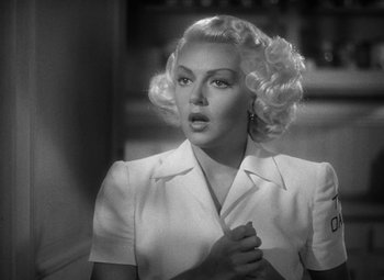 Movie still from “The Postman Always Rings Twice” (1946), directed by Tay Garnett – A black and white photo of a woman with blonde hair; Close Up shot, Over the shoulder angle