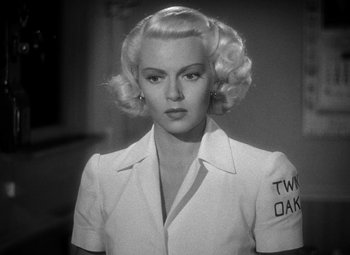 Movie still from “The Postman Always Rings Twice” (1946), directed by Tay Garnett – A black and white photo of a woman with blonde ringlets; Close Up shot, Low angle