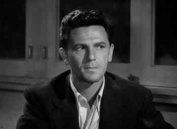 Movie still from “The Postman Always Rings Twice” (1946), directed by Tay Garnett – Black and white photograph of a man wearing a suit; Close Up shot, High angle