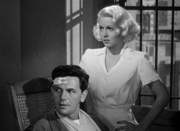 Movie still from “The Postman Always Rings Twice” (1946), directed by Tay Garnett – A man and a woman are standing next to each other; Medium shot, Low angle