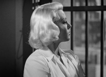 Movie still from “The Postman Always Rings Twice” (1946), directed by Tay Garnett – A black and white photo of a woman with blonde hair; Close Up shot, Low angle