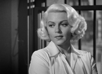 Movie still from “The Postman Always Rings Twice” (1946), directed by Tay Garnett – A black and white photo of a woman with blonde hair; Close Up shot, Low angle