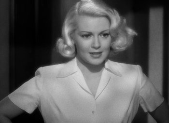 Movie still from “The Postman Always Rings Twice” (1946), directed by Tay Garnett – A black - and - white photo of a woman with blonde hair; Close Up shot, Over the shoulder angle