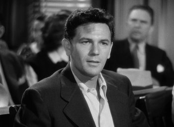 Movie still from “The Postman Always Rings Twice” (1946), directed by Tay Garnett – Black and white photograph of a man wearing a suit; Close Up shot, High angle