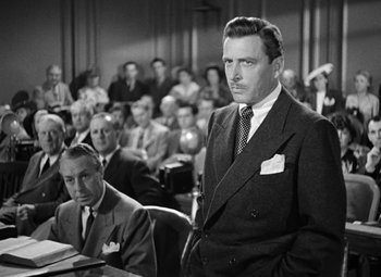 Movie still from “The Postman Always Rings Twice” (1946), directed by Tay Garnett – A man standing in front of a crowd of people; Medium shot, Low angle