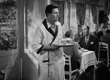 Movie still from “The Postman Always Rings Twice” (1946), directed by Tay Garnett – A man holding a tray in front of a man in a suit; Medium shot, Low angle