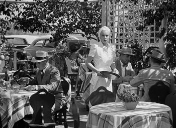 Movie still from “The Postman Always Rings Twice” (1946), directed by Tay Garnett – An old black and white photo of people sitting at tables; Wide shot, High angle