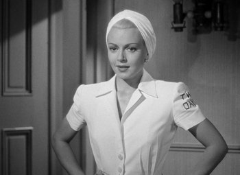 Movie still from “The Postman Always Rings Twice” (1946), directed by Tay Garnett – A black - and - white photo of a woman with a towel on her head; Medium shot, Low angle