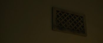 Movie still from “The Power” (2021), directed by Corinna Faith – An air vent on the wall of a room; Extreme Close Up shot, Low angle