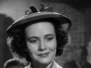 Movie still from “The Pride of the Yankees” (1942), directed by Sam Wood – A woman wearing a hat with a bow in her hair; Close Up shot, Low angle