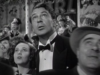 Movie still from “The Pride of the Yankees” (1942), directed by Sam Wood – A black and white photo of a man in a tuxedo; Close Up shot, Low angle