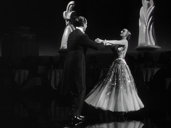 Movie still from “The Pride of the Yankees” (1942), directed by Sam Wood – A man and a woman dancing in formal wear; Wide shot, Low angle