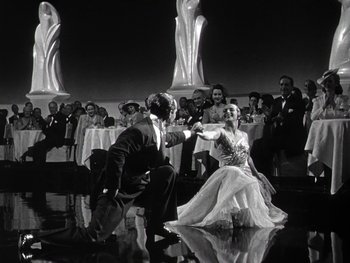 Movie still from “The Pride of the Yankees” (1942), directed by Sam Wood – A man and a woman dancing in front of a crowd; Wide shot, Low angle
