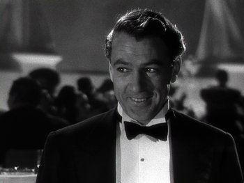 Movie still from “The Pride of the Yankees” (1942), directed by Sam Wood – A black and white photo of a man in a tuxedo; Close Up shot, Low angle