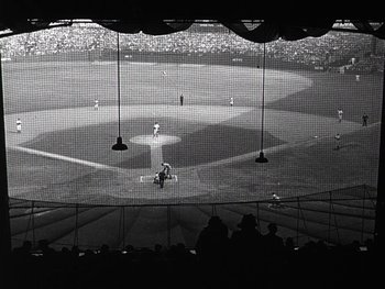 Movie still from “The Pride of the Yankees” (1942), directed by Sam Wood – A baseball game is being played on a big screen; Extreme Wide shot, High angle