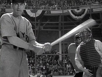 Movie still from “The Pride of the Yankees” (1942), directed by Sam Wood – A man holding a baseball bat while standing next to a crowd; Medium shot, Low angle
