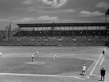 Movie still from “The Pride of the Yankees” (1942), directed by Sam Wood – A black and white photo of a baseball game in progress; Extreme Wide shot, High angle