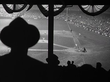 Movie still from “The Pride of the Yankees” (1942), directed by Sam Wood – A black and white photo of a baseball game in progress; Wide shot, Low angle