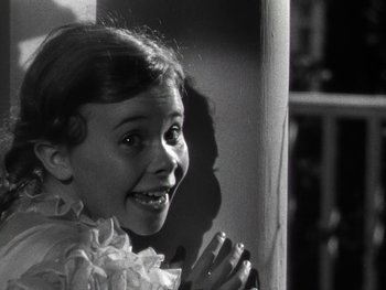 Movie still from “The Pride of the Yankees” (1942), directed by Sam Wood – A little girl in a white dress clapping her hands; Close Up shot, Low angle