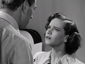 Movie still from “The Pride of the Yankees” (1942), directed by Sam Wood – An old black and white photo of a man and a woman; Close Up shot, Low angle