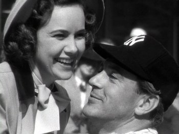 Movie still from “The Pride of the Yankees” (1942), directed by Sam Wood – An old photo of a man and a woman smiling for the camera; Close Up shot, Low angle
