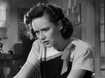 Movie still from “The Pride of the Yankees” (1942), directed by Sam Wood – A woman in a black and white photo looking sad; Close Up shot, Low angle