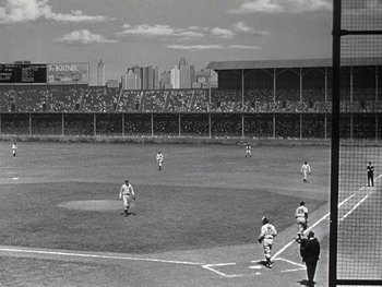 Movie still from “The Pride of the Yankees” (1942), directed by Sam Wood – A black and white photo of a baseball game in progress; Extreme Wide shot, High angle
