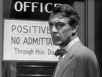 Movie still from “The Pride of the Yankees” (1942), directed by Sam Wood – A man standing in front of an office sign; Close Up shot, Over the shoulder angle