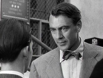 Movie still from “The Pride of the Yankees” (1942), directed by Sam Wood – A black and white photo of a man wearing a suit and a bow tie; Close Up shot, Over the shoulder angle