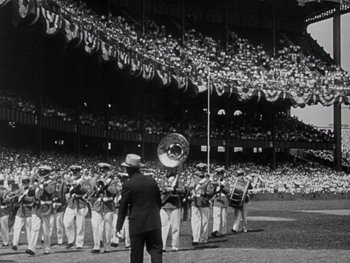 Movie still from “The Pride of the Yankees” (1942), directed by Sam Wood – An old photo of a band playing in a baseball game; Extreme Wide shot, High angle
