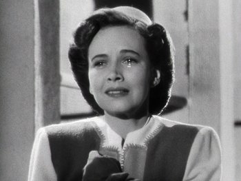 Movie still from “The Pride of the Yankees” (1942), directed by Sam Wood – An old black and white photo of a woman; Close Up shot, Low angle