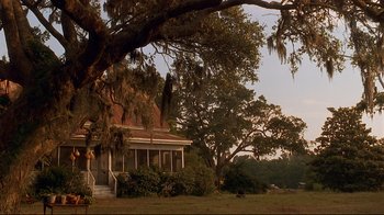 Movie still from “The Prince of Tides” (1991), directed by Barbra Streisand – An old house in the middle of a field with trees; Extreme Wide shot, Low angle