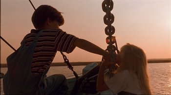 Movie still from “The Prince of Tides” (1991), directed by Barbra Streisand – Two children on a boat at sunset; Medium shot, Low angle