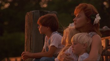 Movie still from “The Prince of Tides” (1991), directed by Barbra Streisand – A group of people sitting next to each other on a bench; Medium shot, Low angle