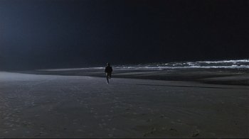 Movie still from “The Prince of Tides” (1991), directed by Barbra Streisand – A person walking on the beach at night; Extreme Wide shot, High angle