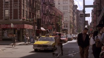 Movie still from “The Prince of Tides” (1991), directed by Barbra Streisand – A busy city street filled with cars and pedestrians; Wide shot, Over the shoulder angle